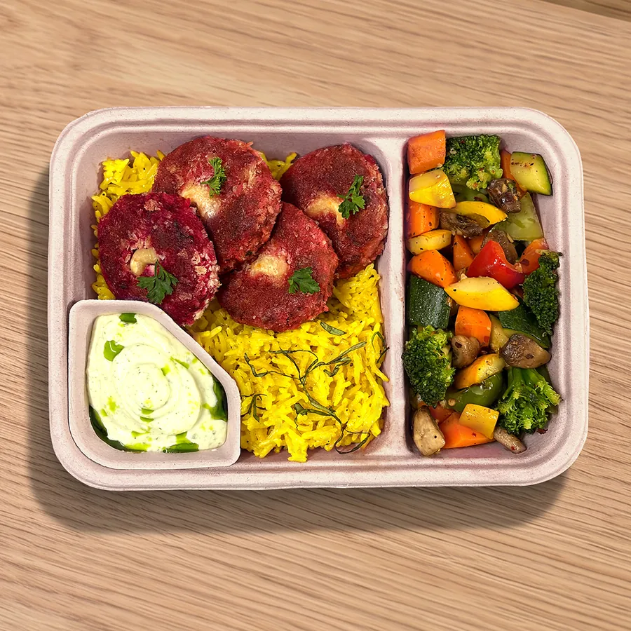 A FOJO tray of beetroot soya tikkis with turmeric rice, saut&eacute;ed vegetables and a yogurt dip
