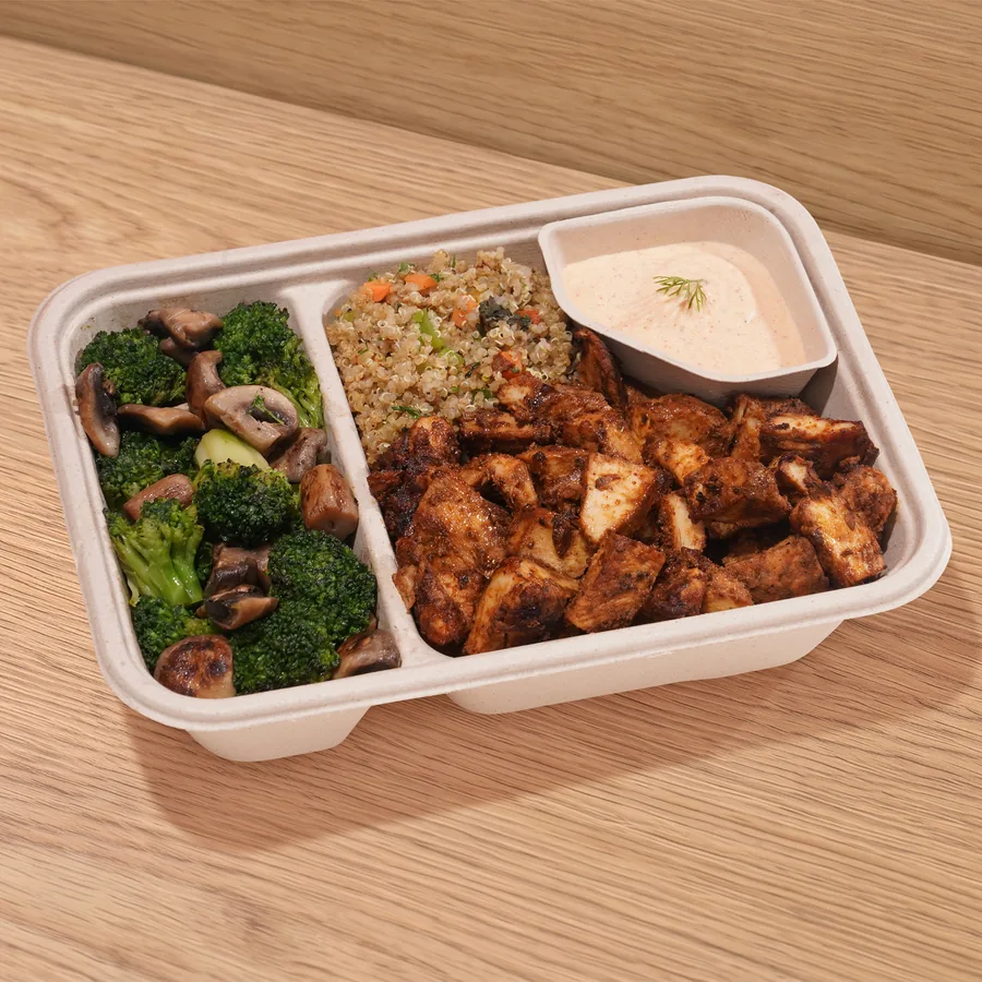 A FOJO tray of cajun chicken with quinoa, broccoli and mushroom saut&eacute; and sriracha yogurt