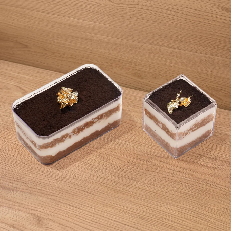 FOJO tiramisu in a box and a cube, dusted with cocoa and topped with gold leaf