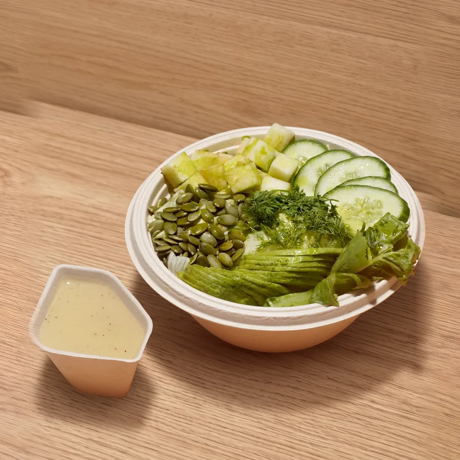 A FOJO Green Goddess salad with cucumber, avocado and pumpkin seeds, dressing on the side